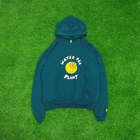 CHEERS HOODIE | DARK GREEN, Long sleeve Relaxed Fit, Drawstring, Hood Ribbed Trims, Yellow woven flag logo at the left sleeve, Collaboration with Smiley, Color: Dark Green, Material: 100% Cotton